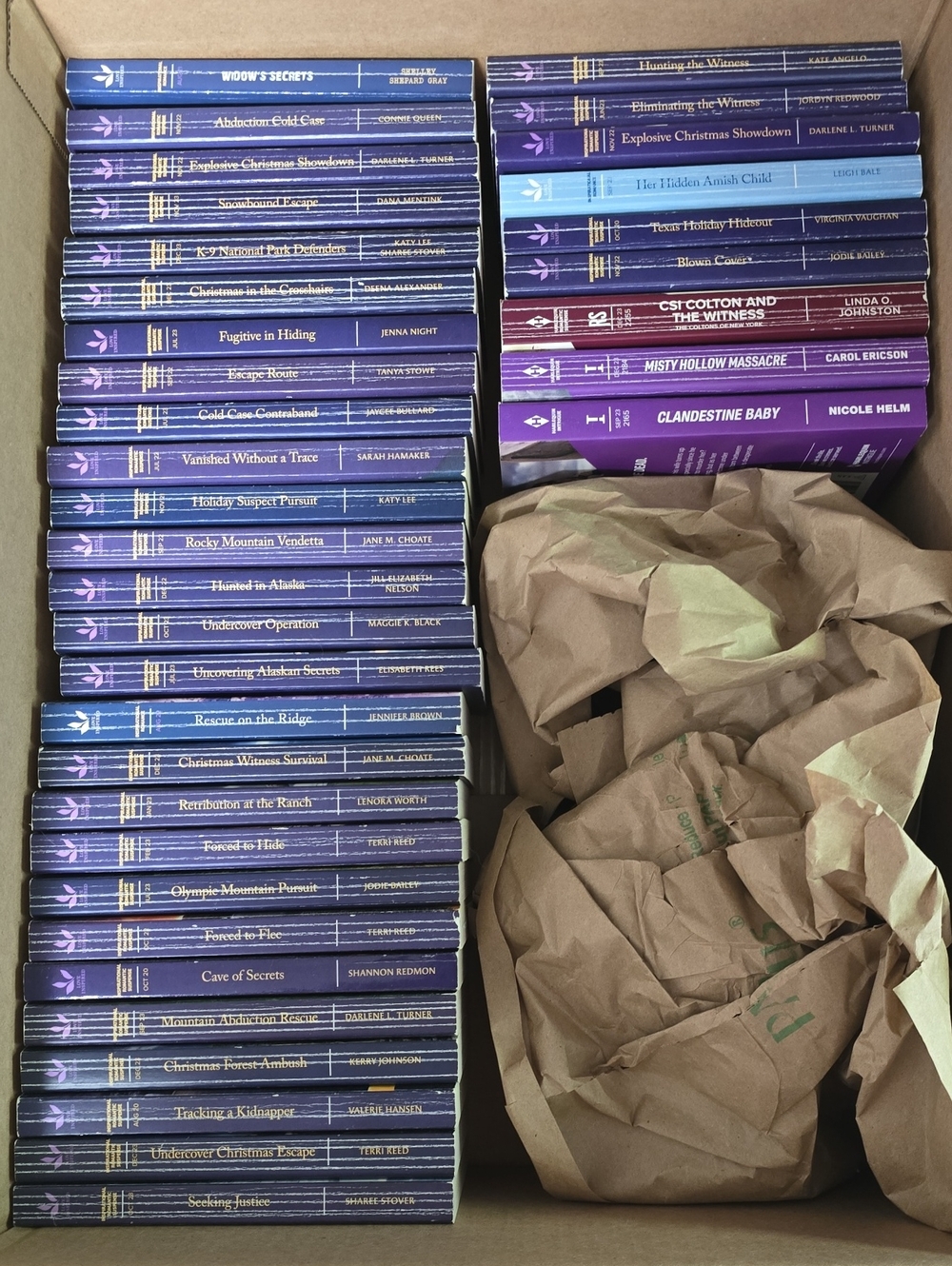 A Box Full Of 36 Harlequin Love Inspired Suspense Paperback Books.